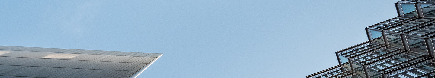 Looking up at the tops of skyscrapers and a blue sky