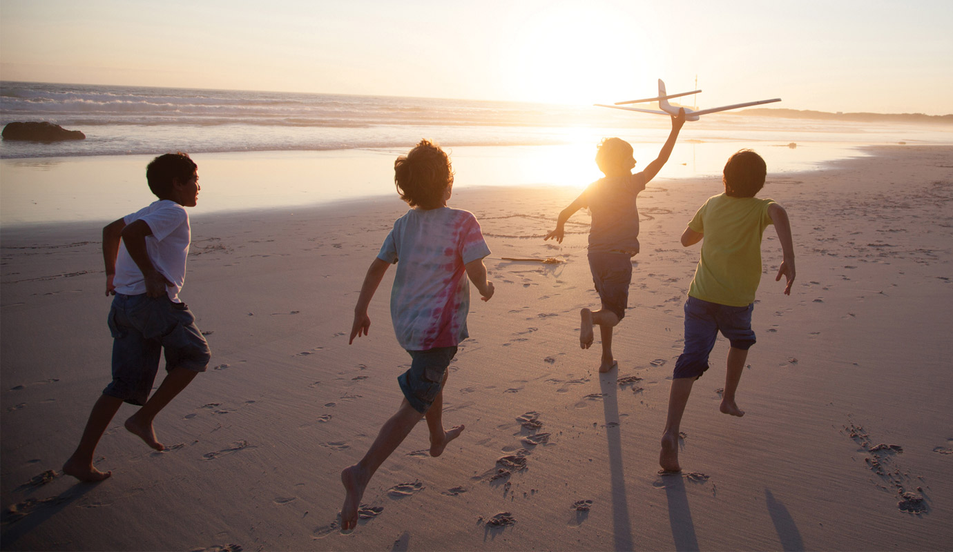 Children running on the beach
