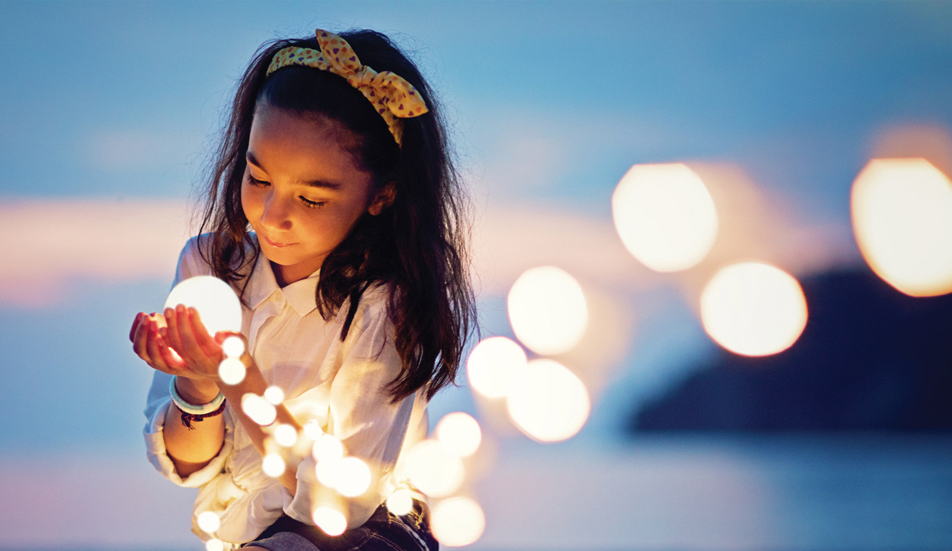 Little girl with string lights