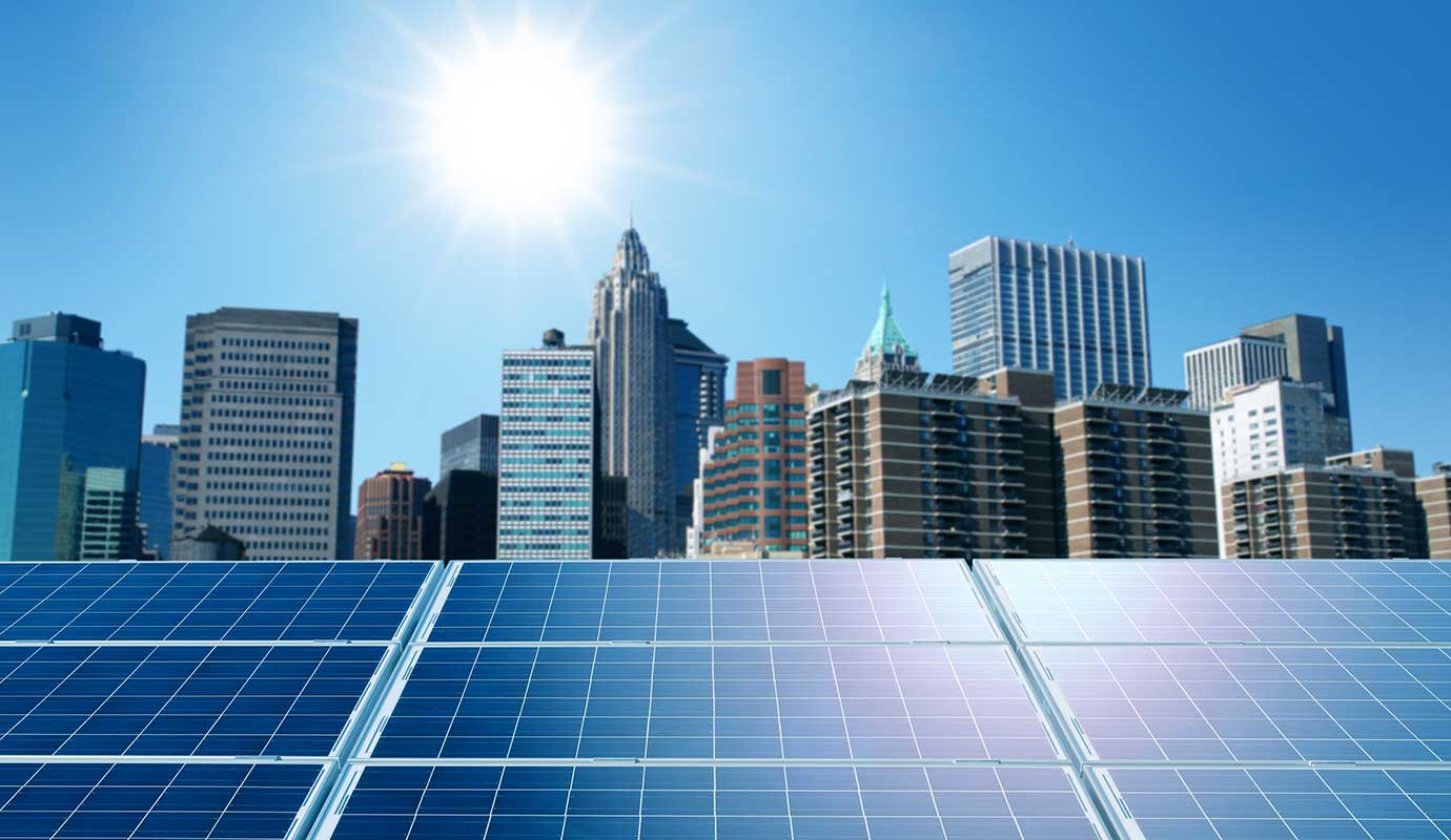 Solar panels with city skyline and sun