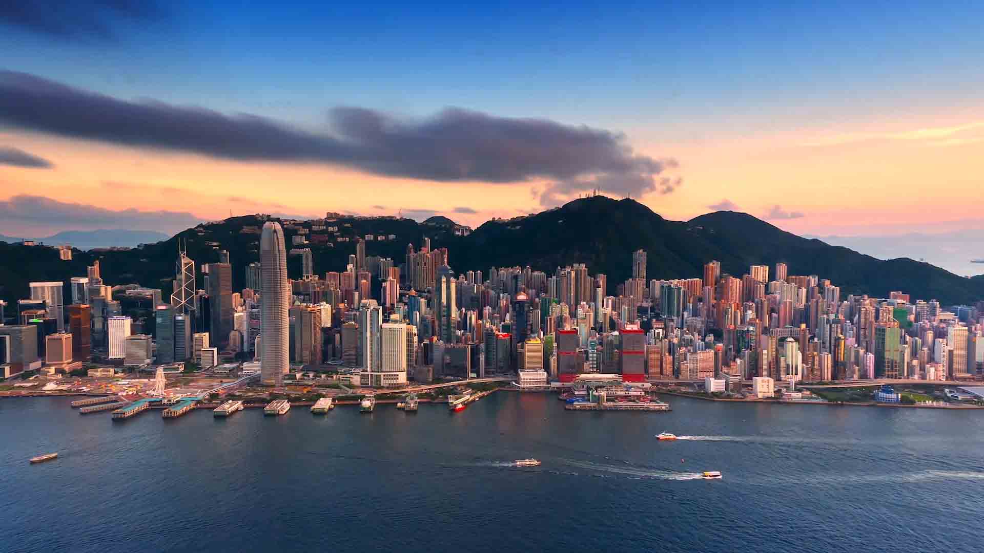 Hong Kong over Victoria Harbour at sunset