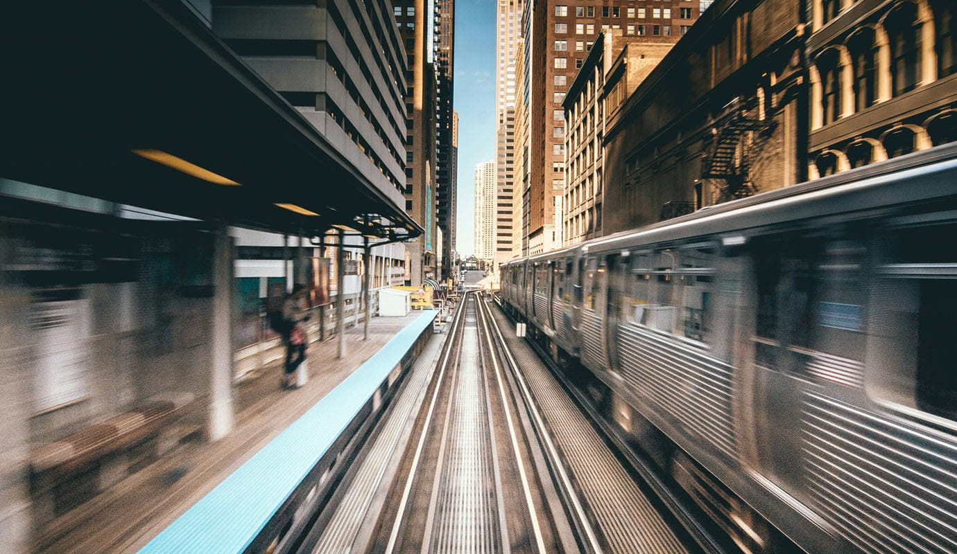 Elevated train station and a subway train in motion
